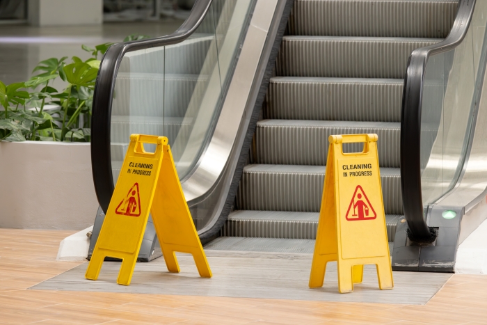 The signs warn people to be careful while using the escalator